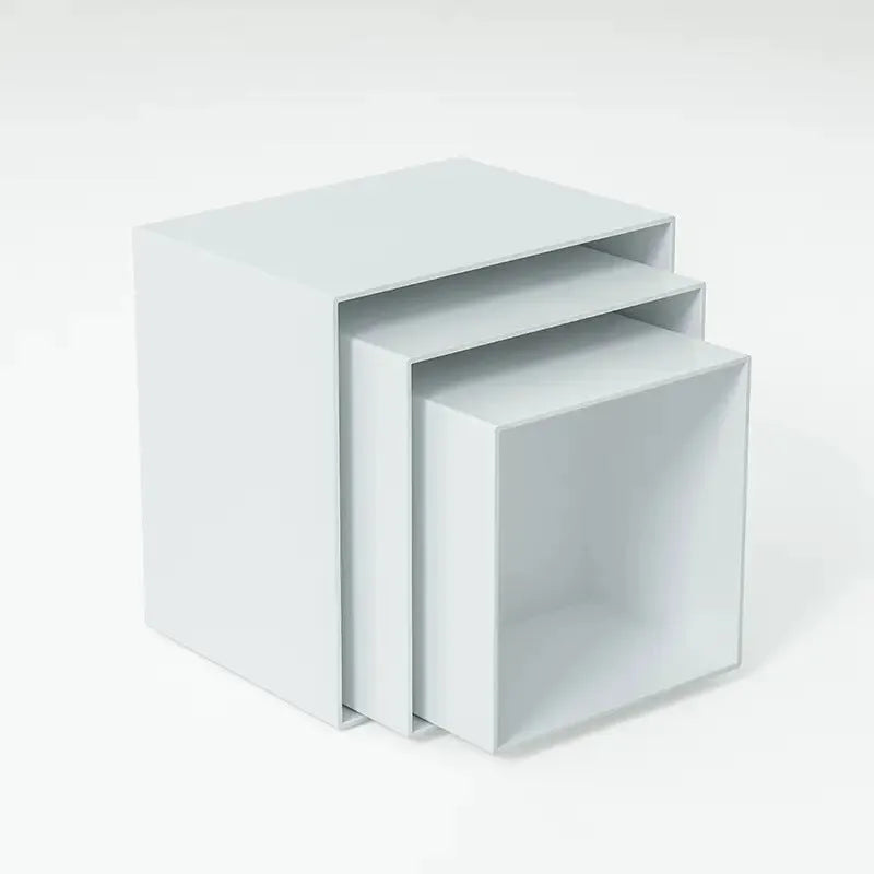 Six white geometric cube dessert display stands arranged on a table.