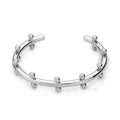 Stainless steel C-shaped bracelet with textured bean beads and rivet details in gold, steel colour, or steel colour gold finishes