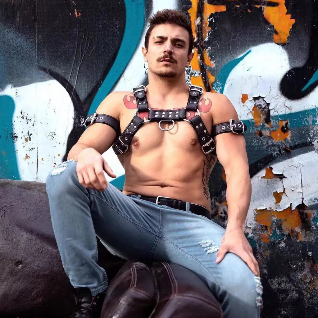 Men's black leather chest muscle bondage strap with metal buckles and adjustable shoulder harness design