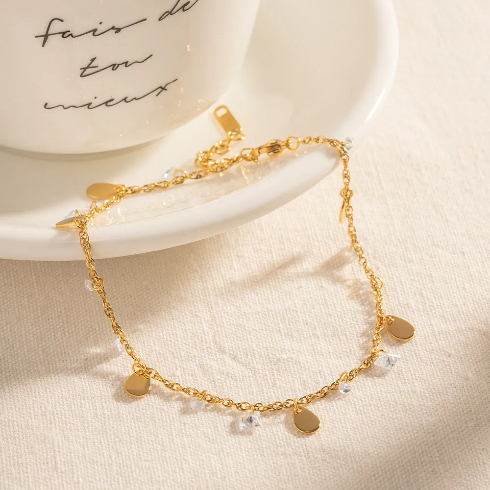 Stainless steel women's anklet with a geometric water drop tassel pendant on an adjustable chain.