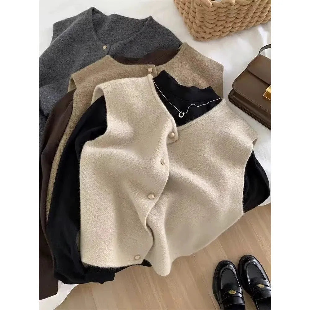 A smoky grey polyester half-sleeve pullover vest laid flat, showing its regular sleeve and commuter style.