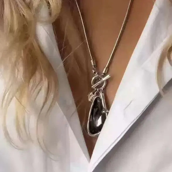 Women's long geometric pendant necklace with plaid pattern on a snake bones chain.