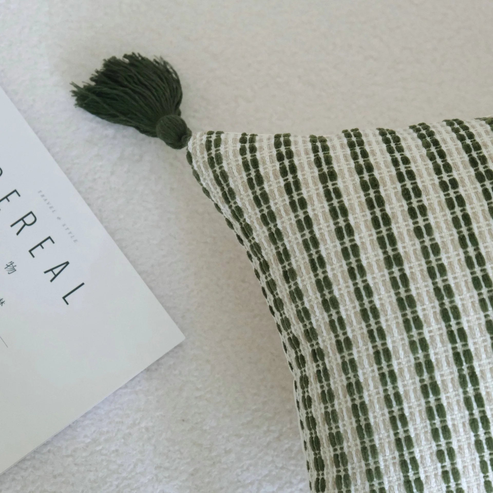 Green cotton and linen hotel sample pillow with tassel or beaded trim, shown in one of three pattern options.
