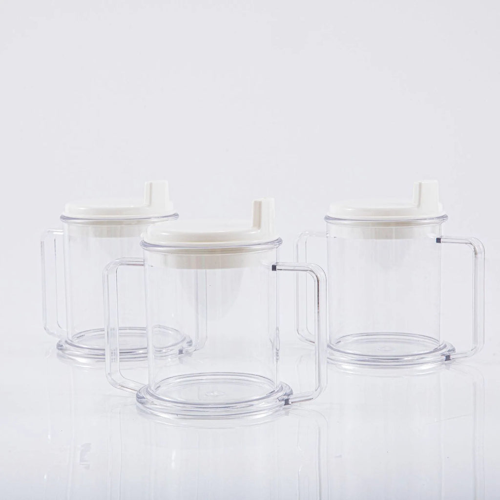 Transparent plastic spill-proof drinking cup on a table