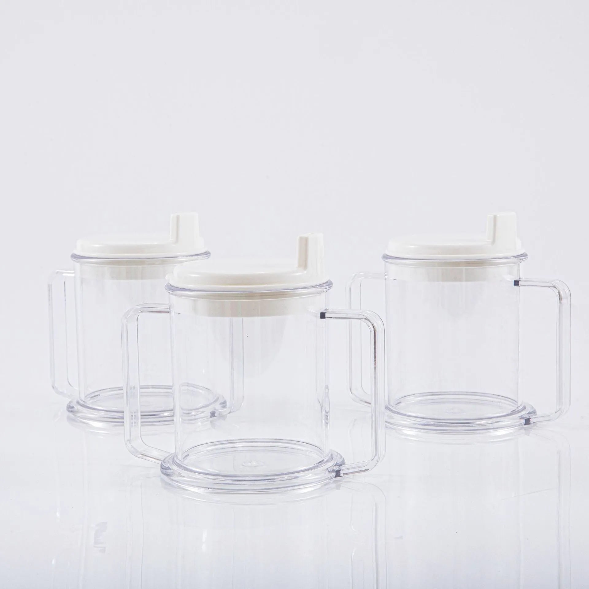 Transparent plastic spill-proof drinking cup on a table