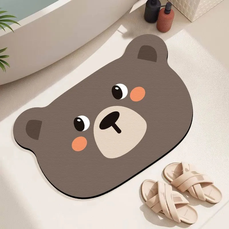 Cartoon animal diatomite absorbent bathroom mat in alien shape on bathroom floor.