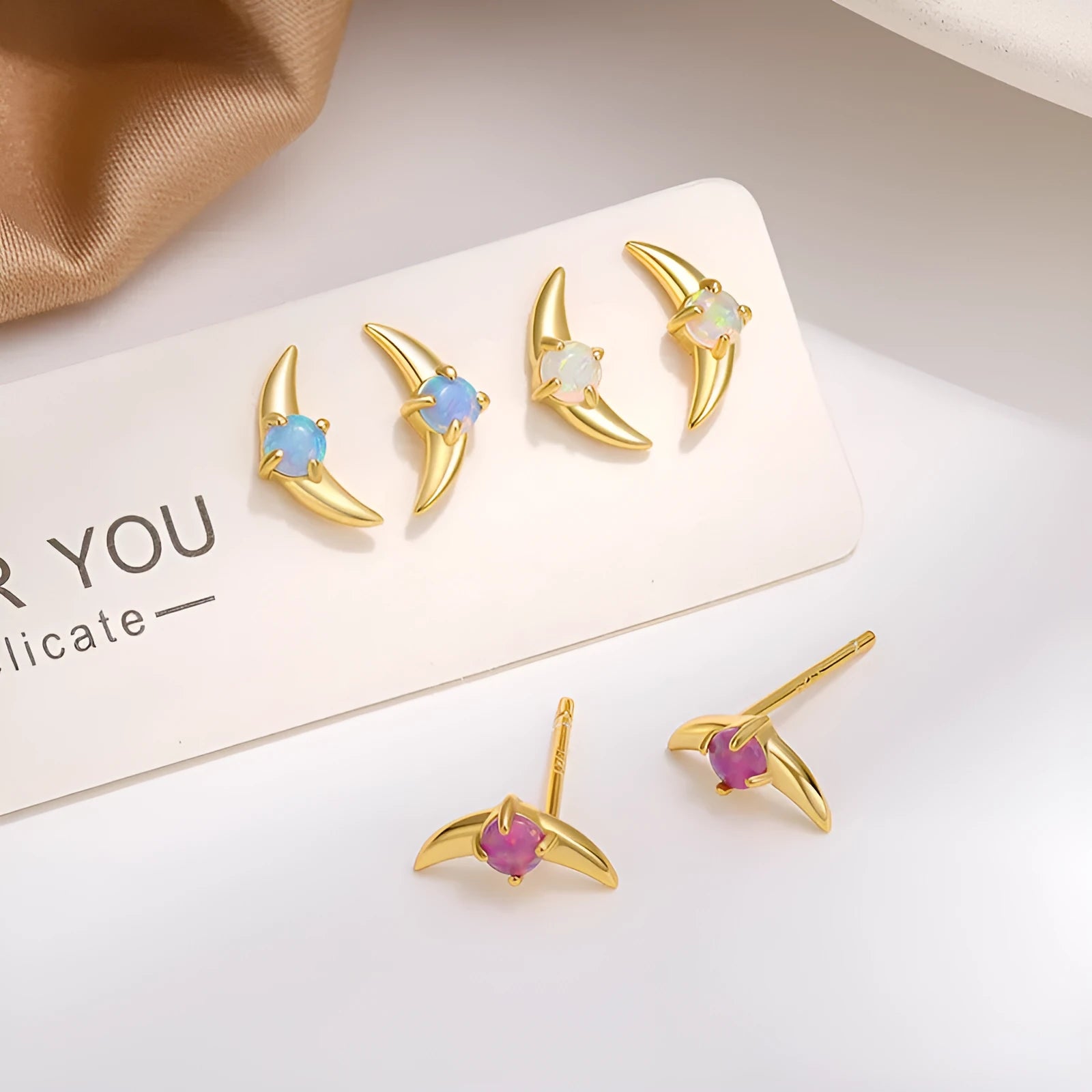 Women's geometric earrings in 925 silver with electroplated gold or platinum finish and coloured stone accents.