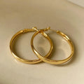 Large circular gold and silver metal hoop earrings measuring 40mm