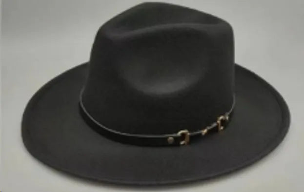 Brown leather velvet cowboy hat with curved brim and conical crown on a wooden post.