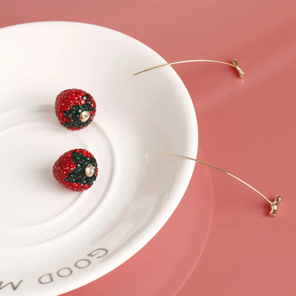 Geometric red strawberry stud earrings with spot drill texture on a zinc alloy post.