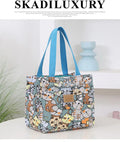 Women's printed floral canvas tote bag with aluminium frame open, showing large interior.