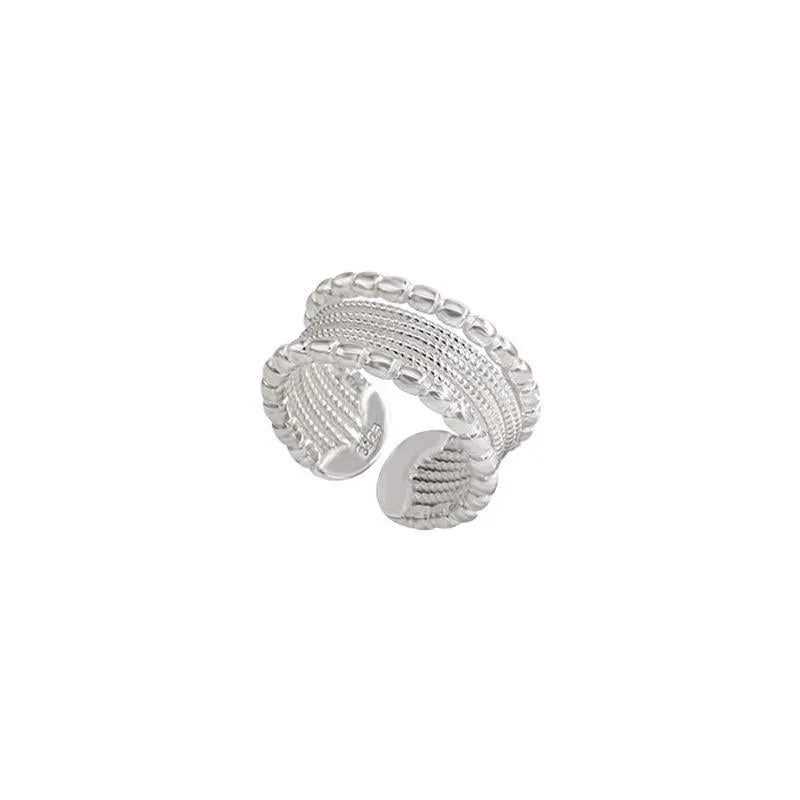 Adjustable geometric ring with woven twisted copper alloy construction