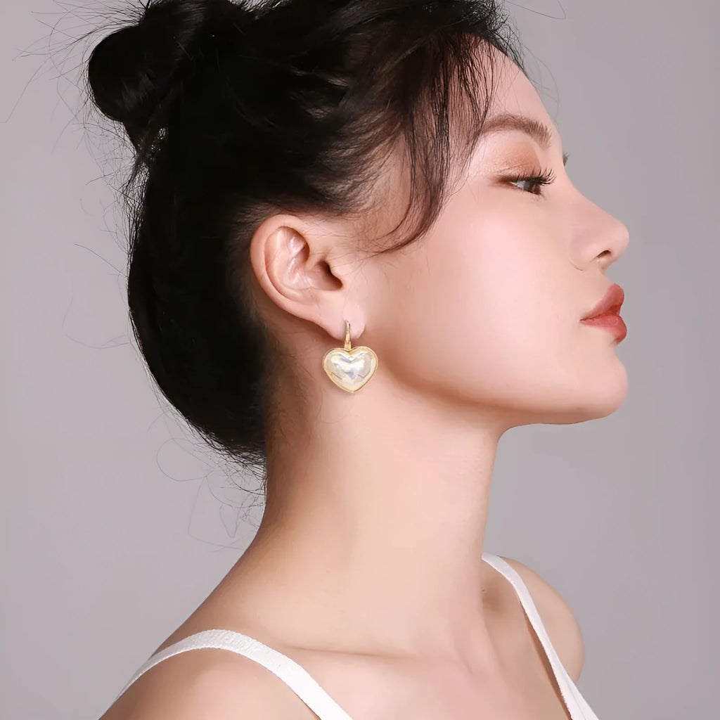 A pair of gold coloured alloy clip-on ear clip earrings for women.