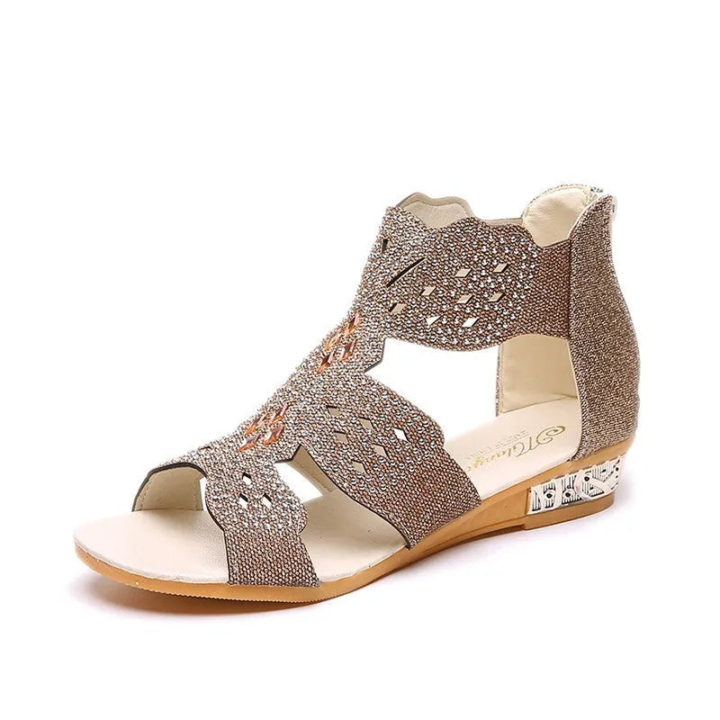 Women's flat open toe sandals with rhinestone details and a back zipper in gold.