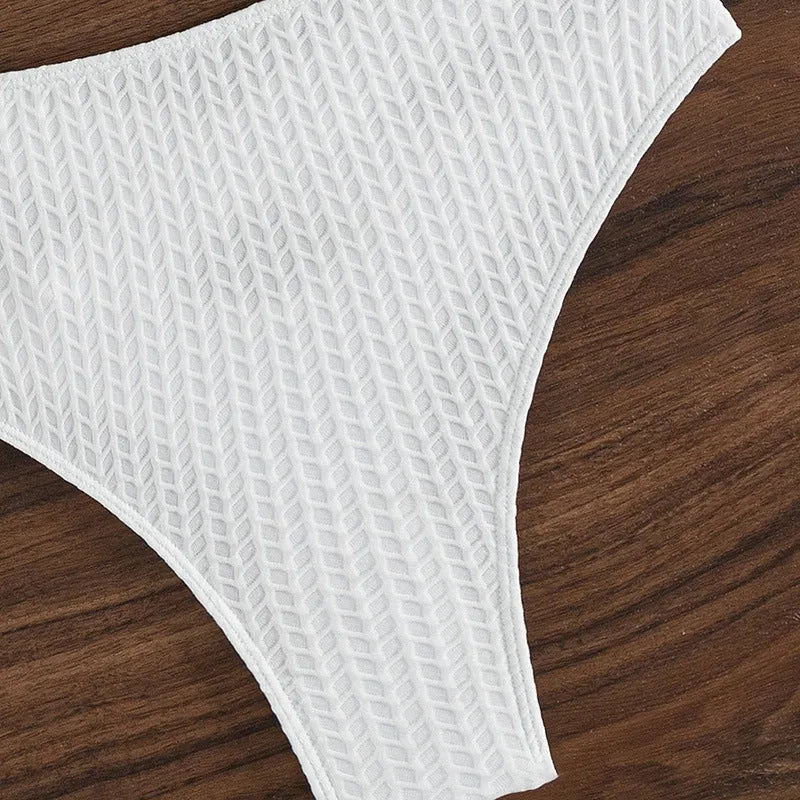 White backless bikini swimsuit with briefs bottom on a mannequin.