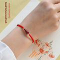 Cinnabar heart charm bracelet with adjustable red rope and traditional safety buckle in multiple colour options