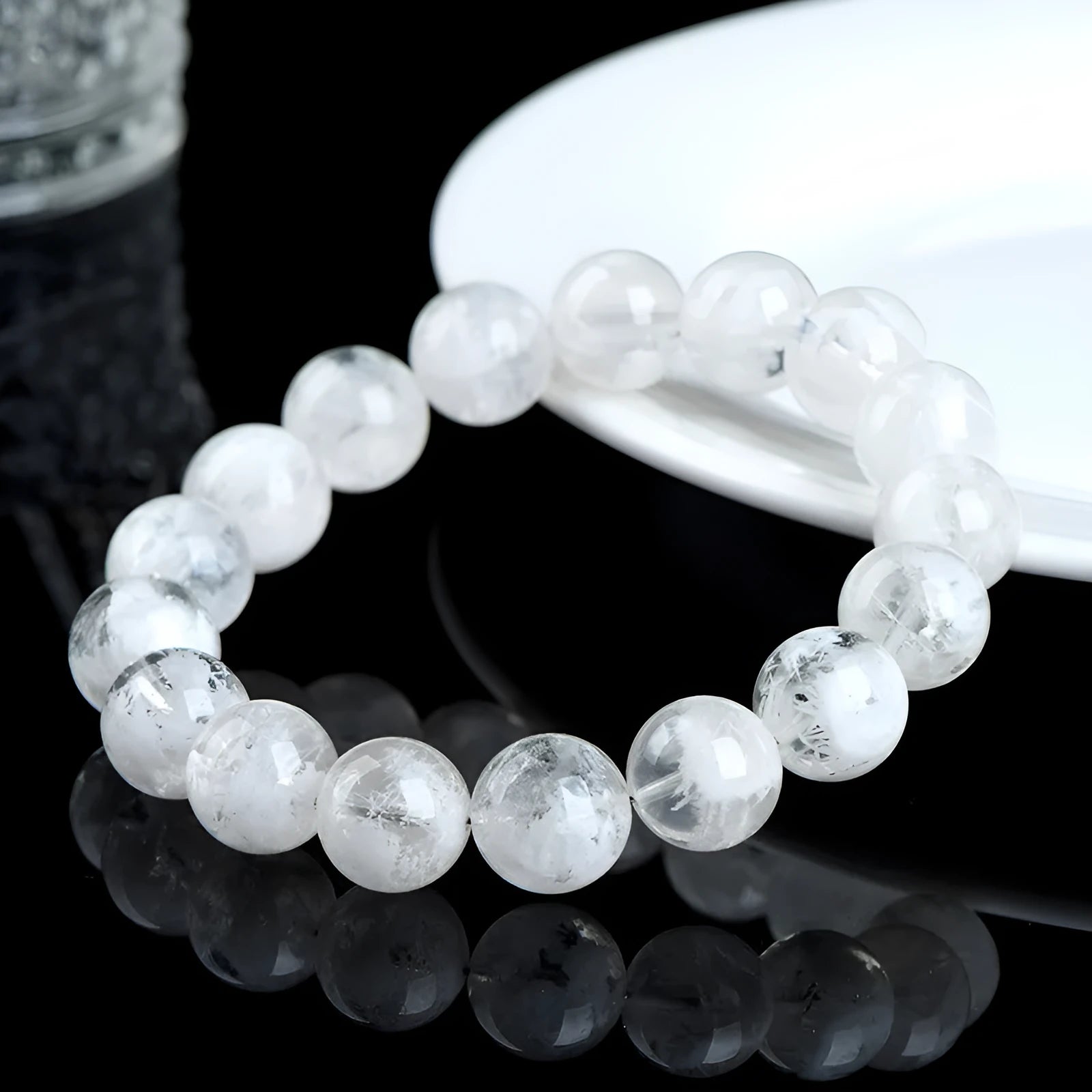 Close-up of a clear crystal blizzard snowflake bead bracelet with Ruyi and Xiangyun design elements.
