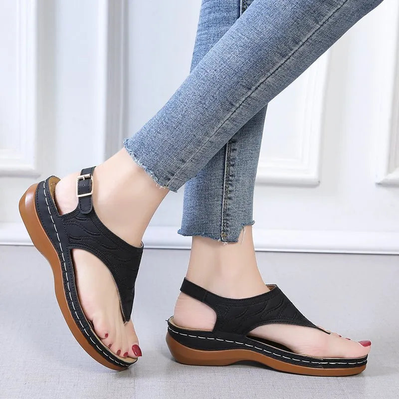 Women's black casual wedge heel flip flop sandals with an adjustable buckle strap.