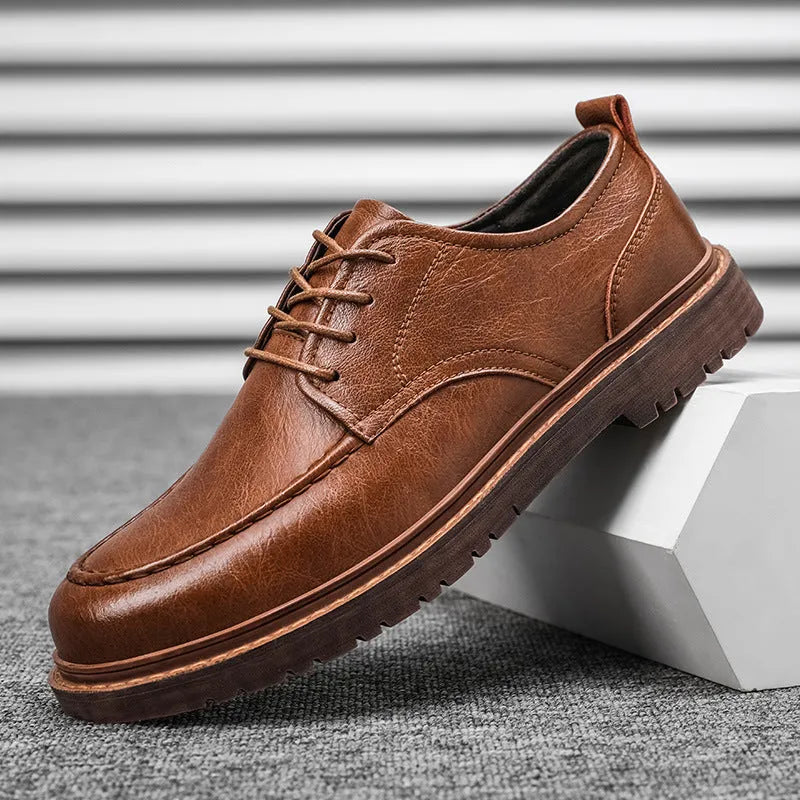 Men's black and brown British-style casual leather shoes with round toe and flat rubber sole.