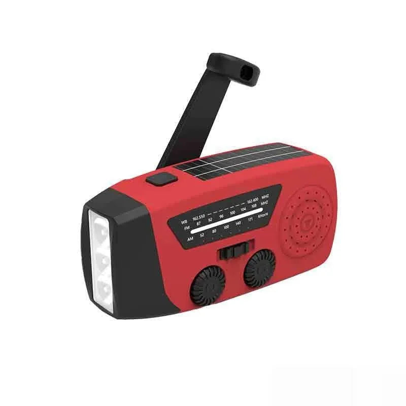 Red rechargeable hand-held emergency radio torch with wrist strap and USB charging port.