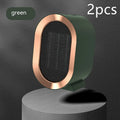 A compact black desktop electric fan heater with mechanical control dials on a wooden desk.