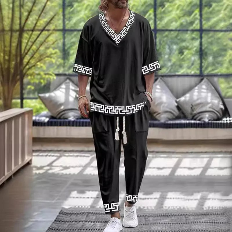 Cropped sleeve V-neck jacket and trousers suit in thin polyester fabric on a hanger.