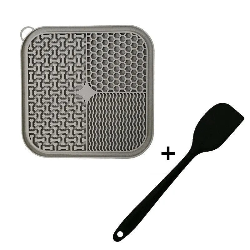 Blue silicone dog licking mat with textured surface and suction cups on a clean floor.