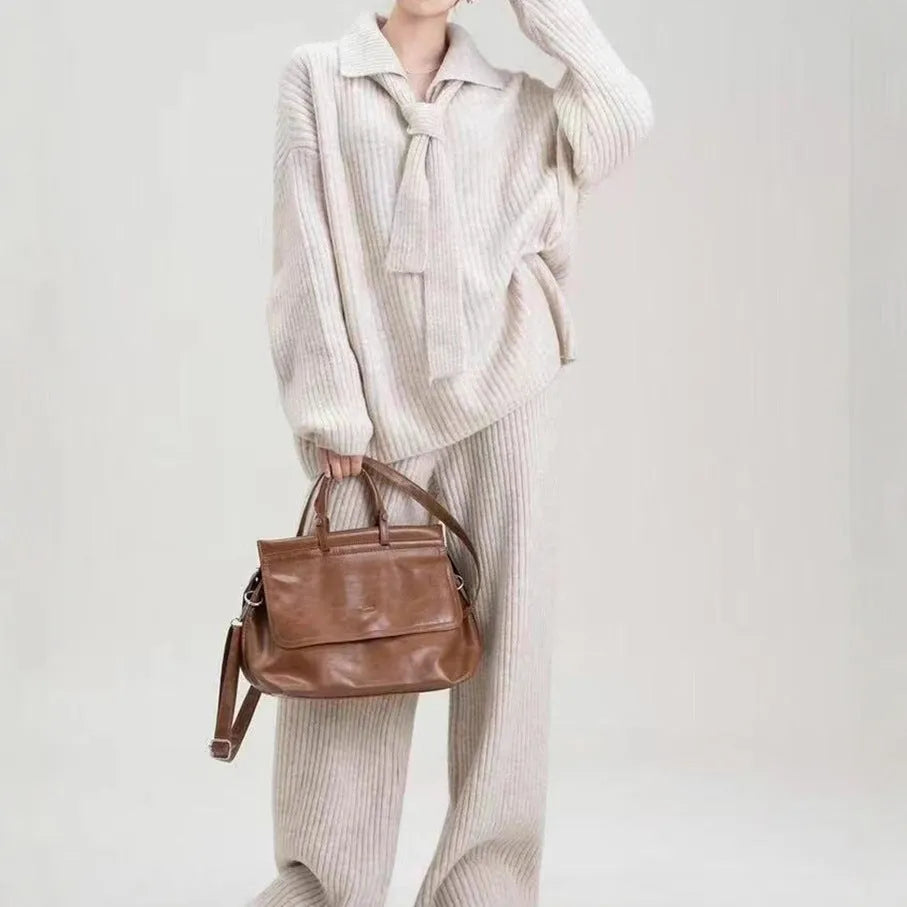 Beige women's acrylic knit top and trouser two-piece set laid flat, showing collage stitching detail on the fabric.