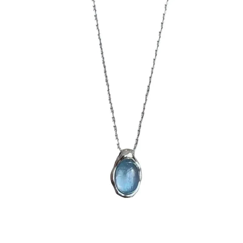 Navy blue geometric water drop pendant necklace on an adjustable cross chain.
