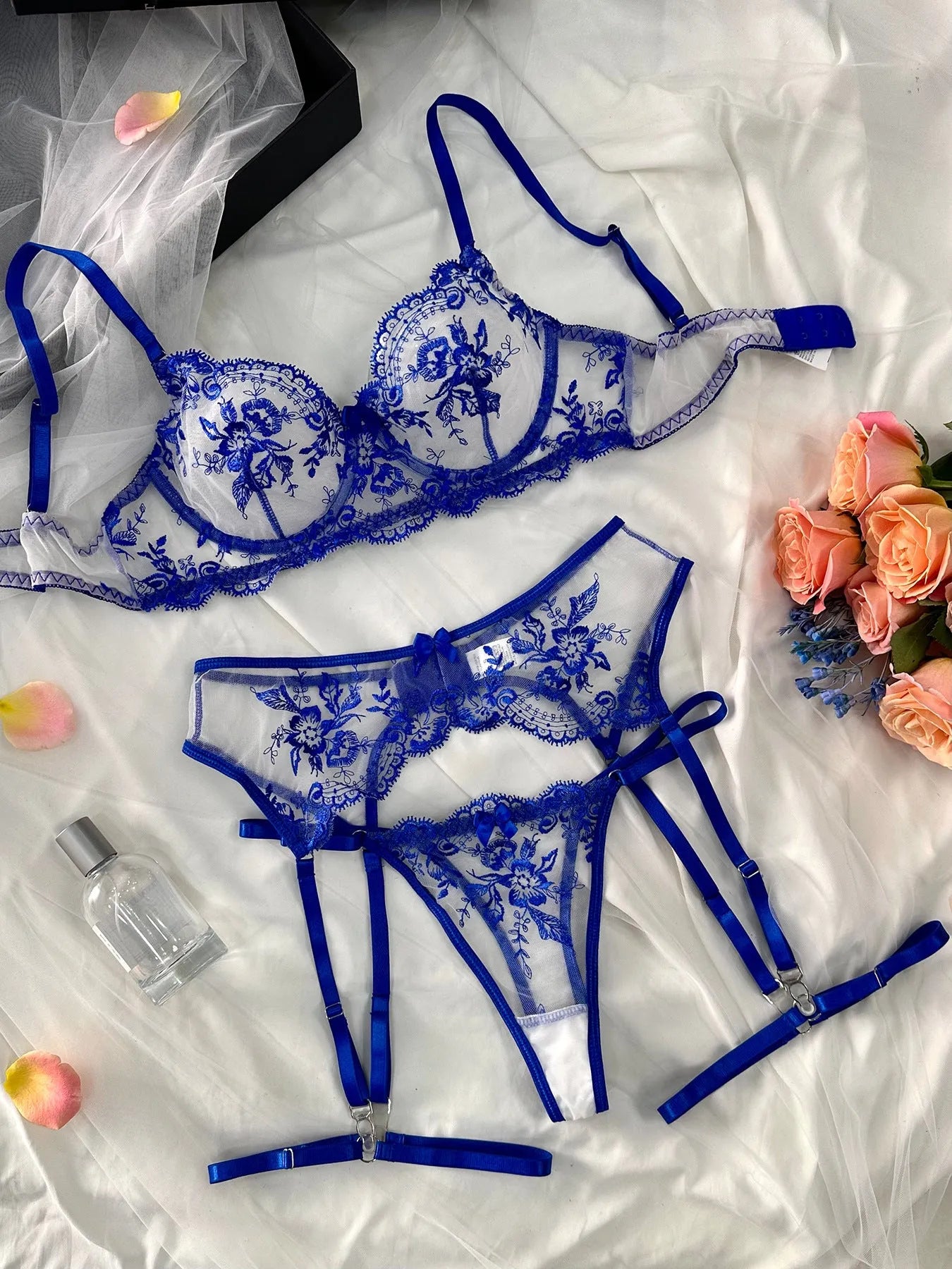 Sapphire blue women's see-through embroidered underwear set with cutouts, includes top, pants, and garters.