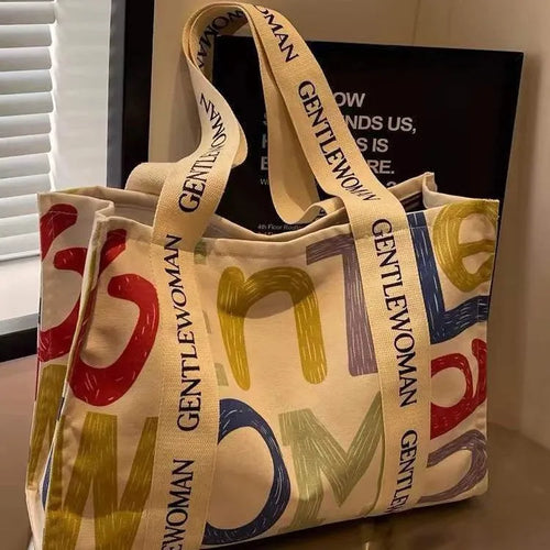 Large canvas women's tote bag with printed design, shown in available colour options.