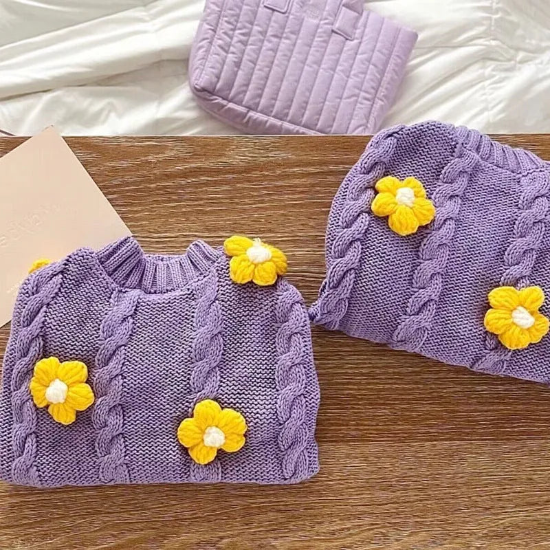 Purple flower print knitted dog jumper shown on a small dog, demonstrating the floral pattern and fit.