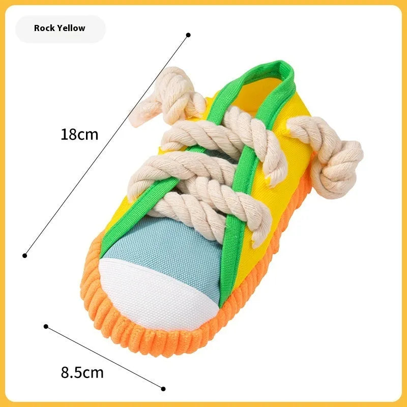 Yellow plastic dog slippers chew toy with a squeaker on a white background.