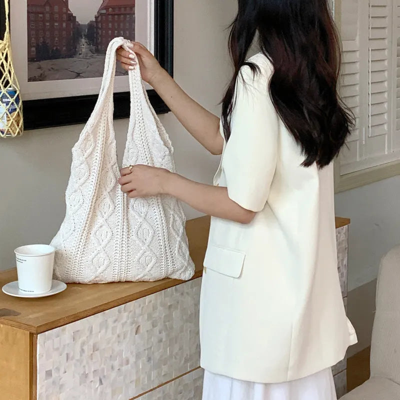 GWomen retro crochet shoulder tote bag in a solid colour, showing knitted texture and double strap connectors.