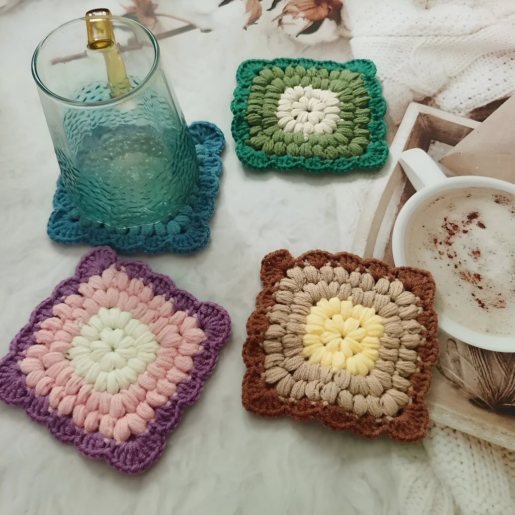 Handcrafted crocheted wool coaster with Grandmother Lattice stitch in a purple colour.