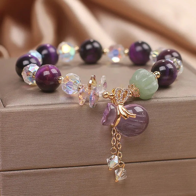 Women's forest style crystal bracelet with purple Tigereye money bag pendant and rhinestone details