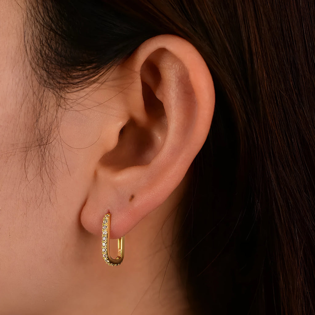 Sterling Silver oval geometric zircon ear clip earrings for women on a white background.