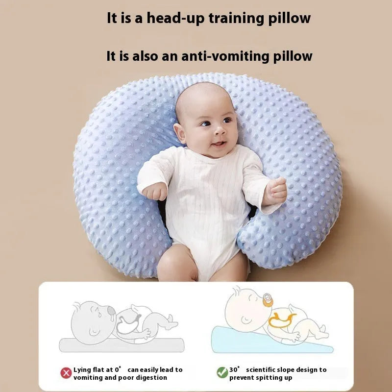 Nursing pillow with removable cover in light blue, featuring a built-in milk spilt preventer.
