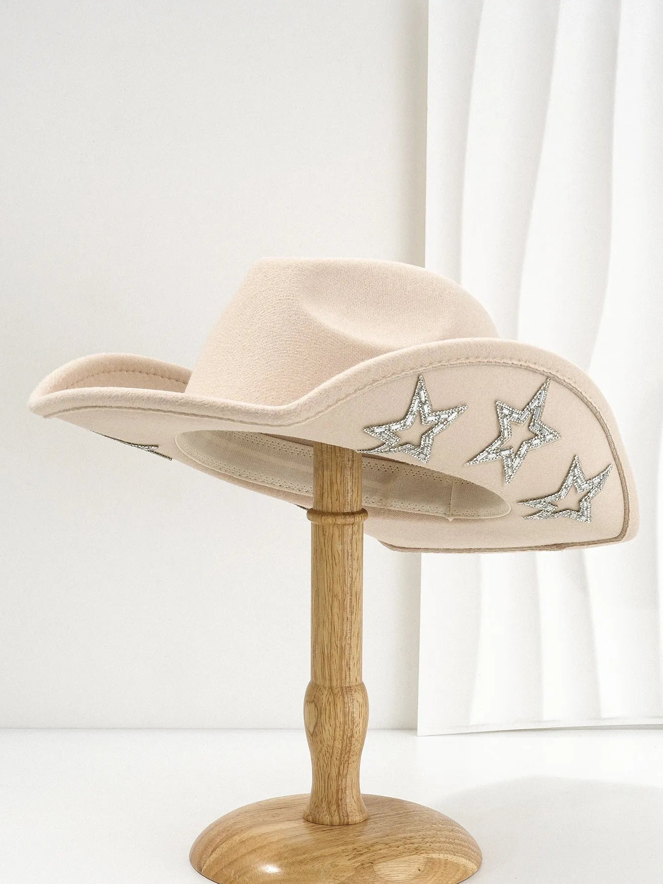 Beige woven polyester western top hat with a conical crown and a hexagonal star decoration on the front.