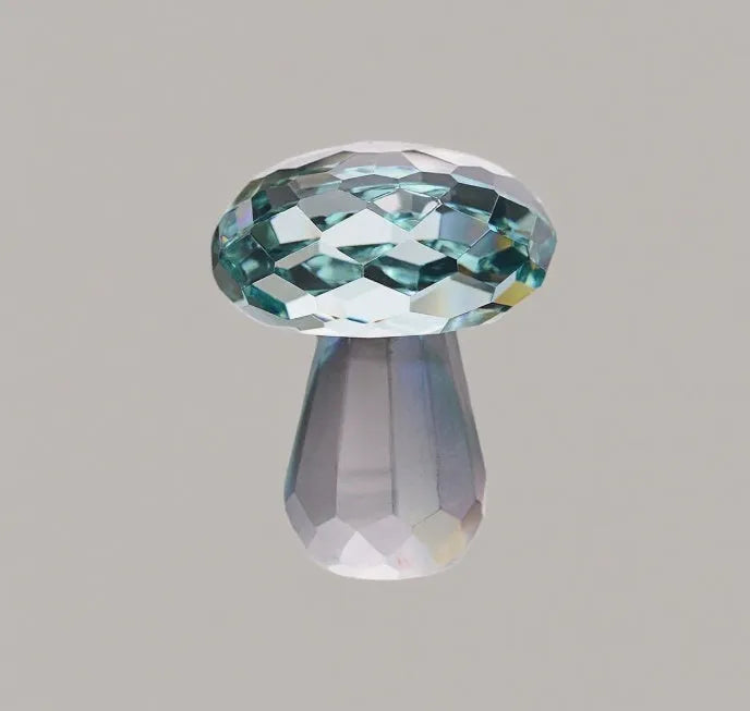 Solid resin crystal mushroom decoration in light green on a wooden surface