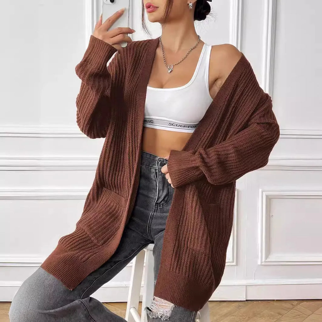Dark green loose women's cardigan with two pockets and long sleeves.