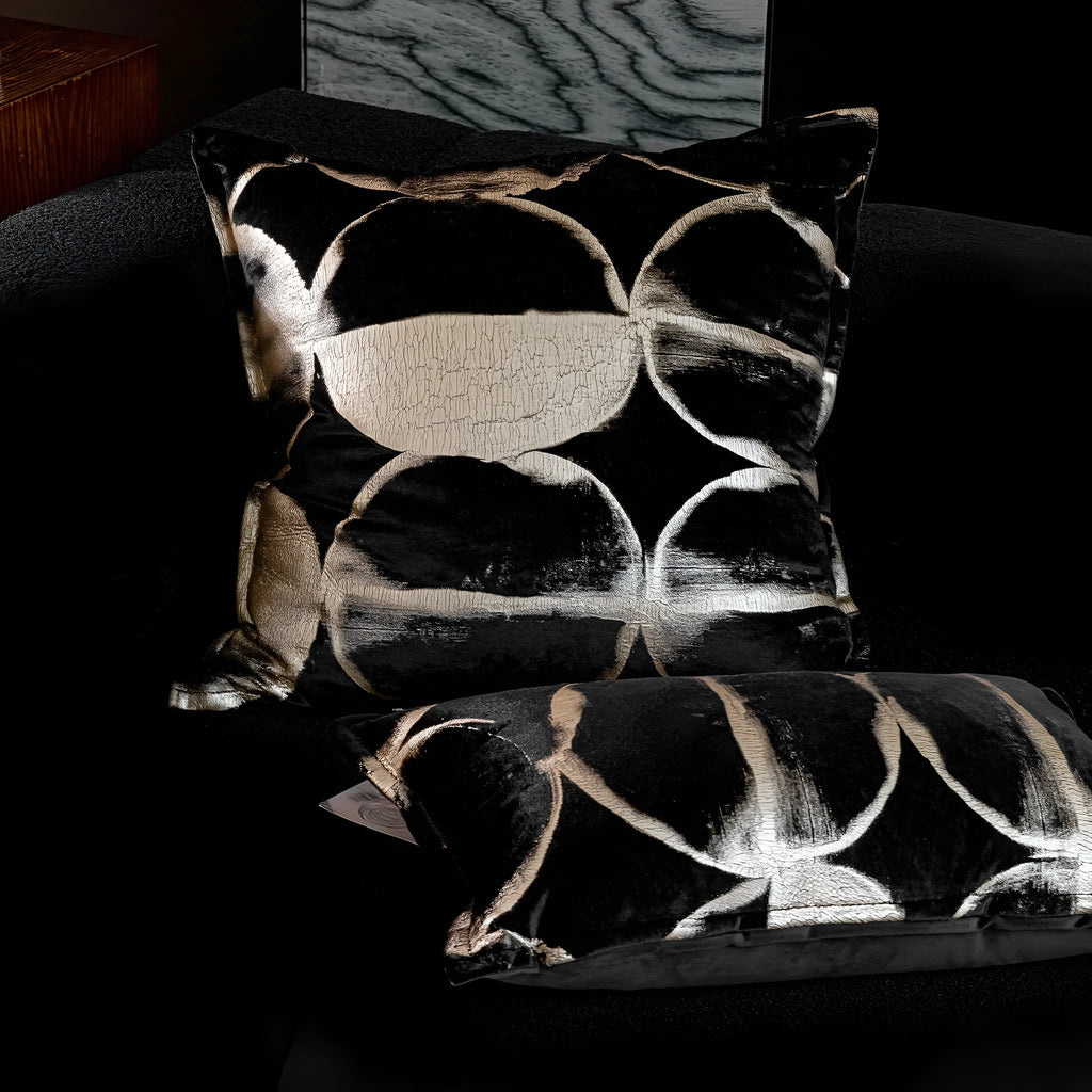 Black and gold abstract pattern flannel cushion cover on a sofa