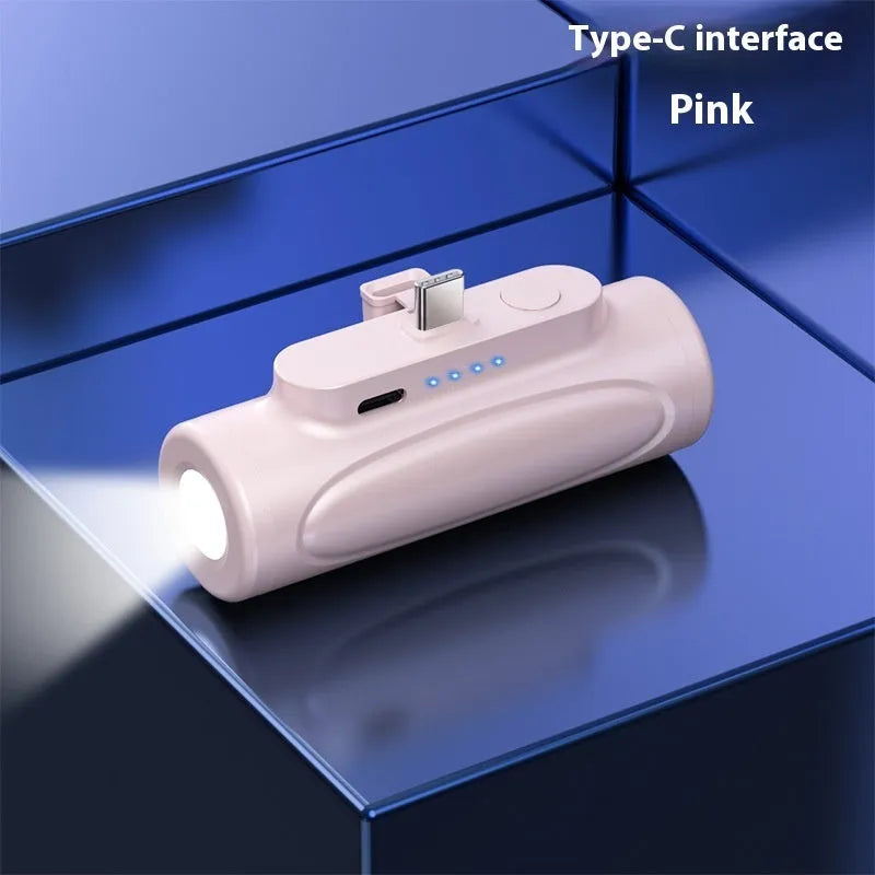 Black and pink Creative Power Bank with integrated LED flashlight, showing Apple and Type-C port options.