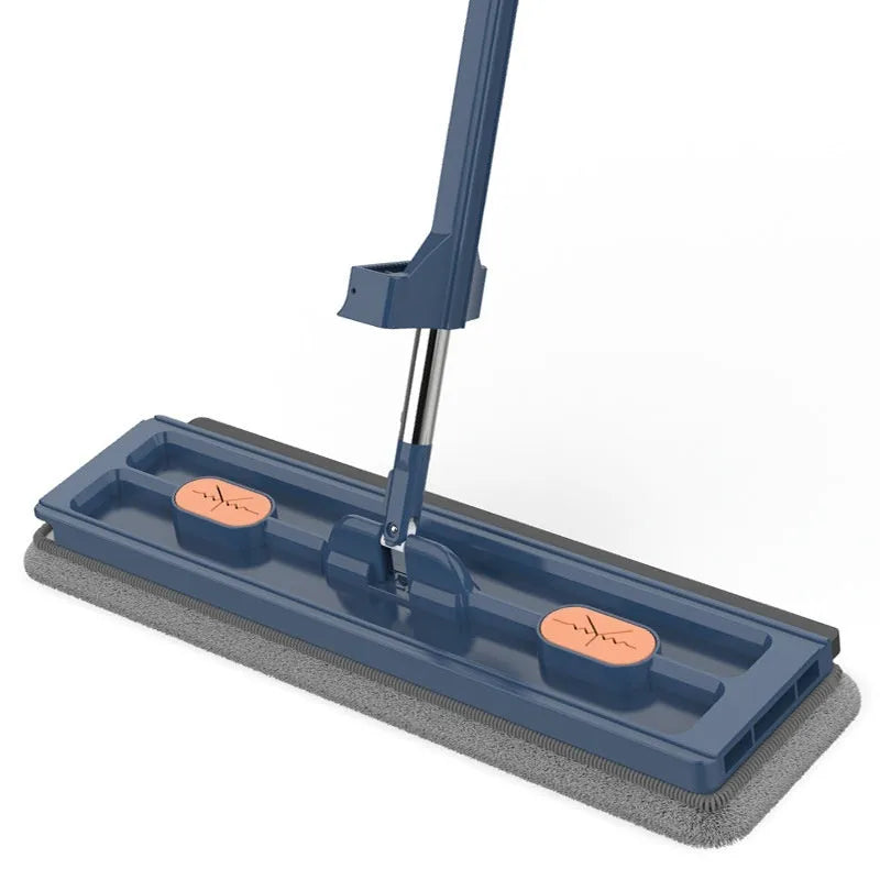Large blue flat mop with a long stainless steel handle and a rotating head on a wooden floor.