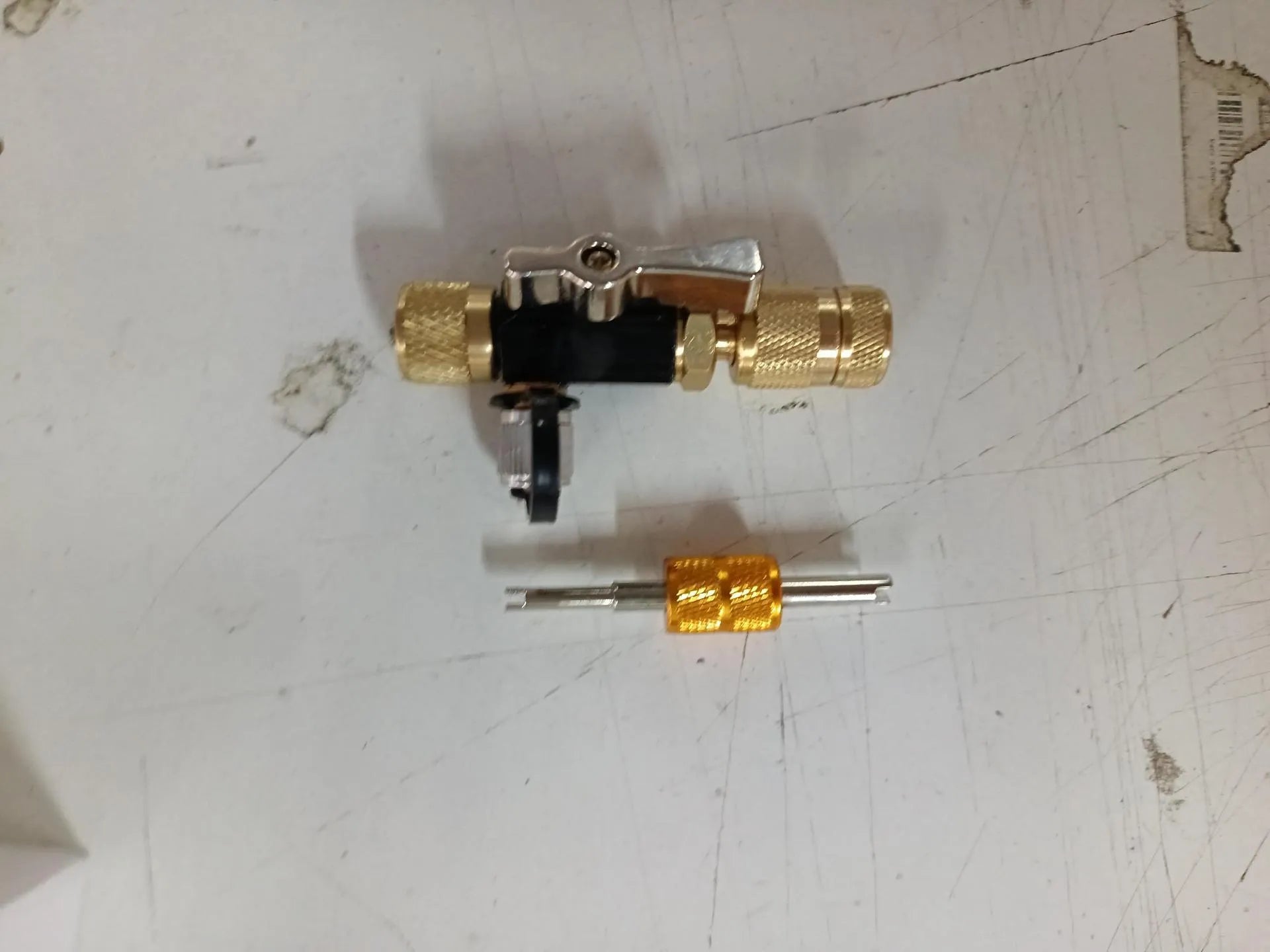 Vacuum valve core disassembly tool set showing metal removers in black and pink for 1/4 and 5/16 inch Schrader valves.