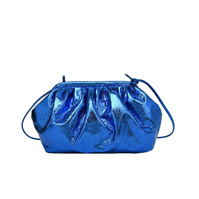 Shoulder crossbody bag with hair clip closure in shell shape design showing interior compartments
