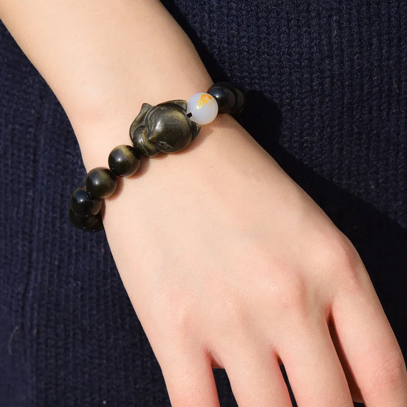 Natural obsidian bracelet with zodiac charm in gold, silver, or black stone styles.