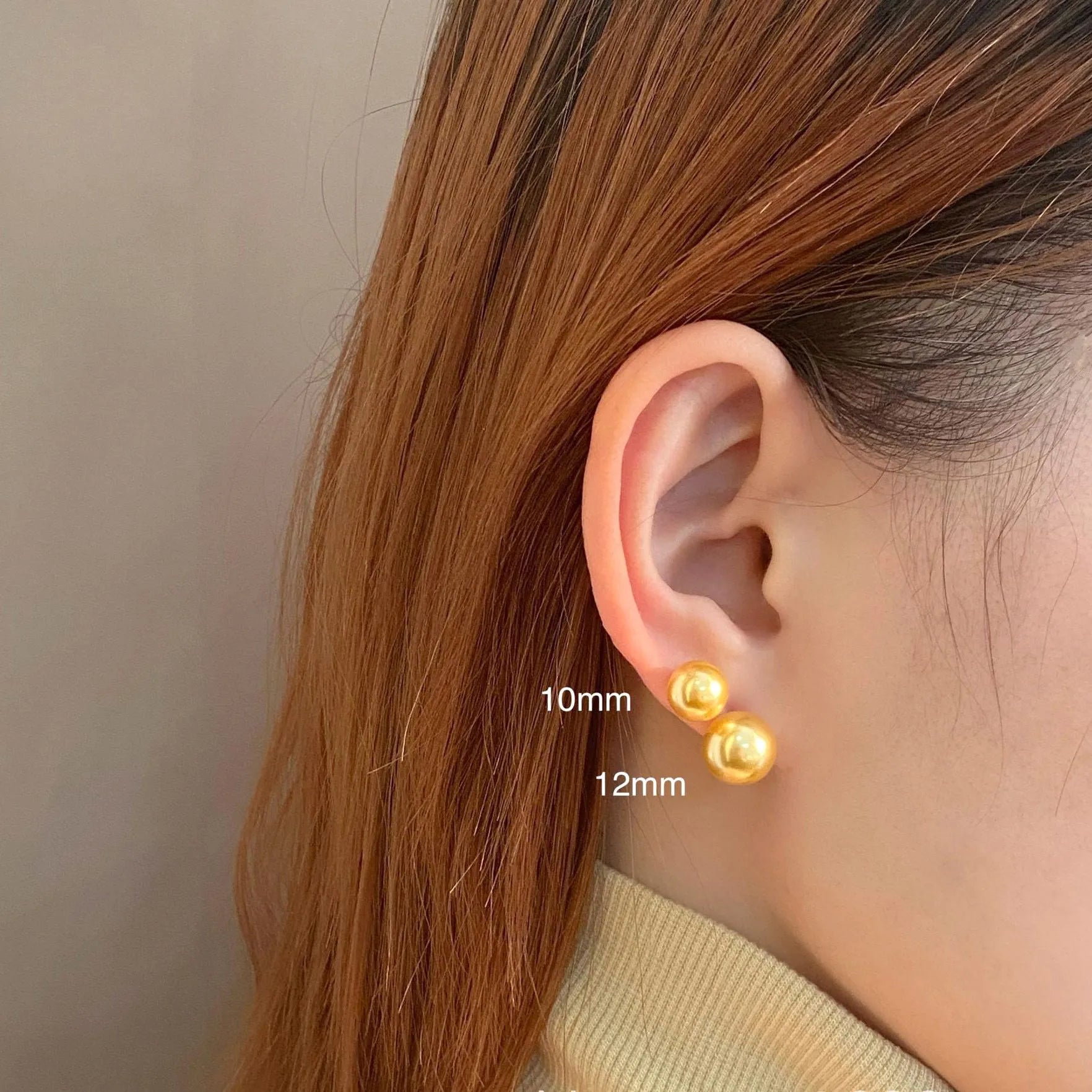 Large pearl stud earrings with a geometric star detail, shown in silver.