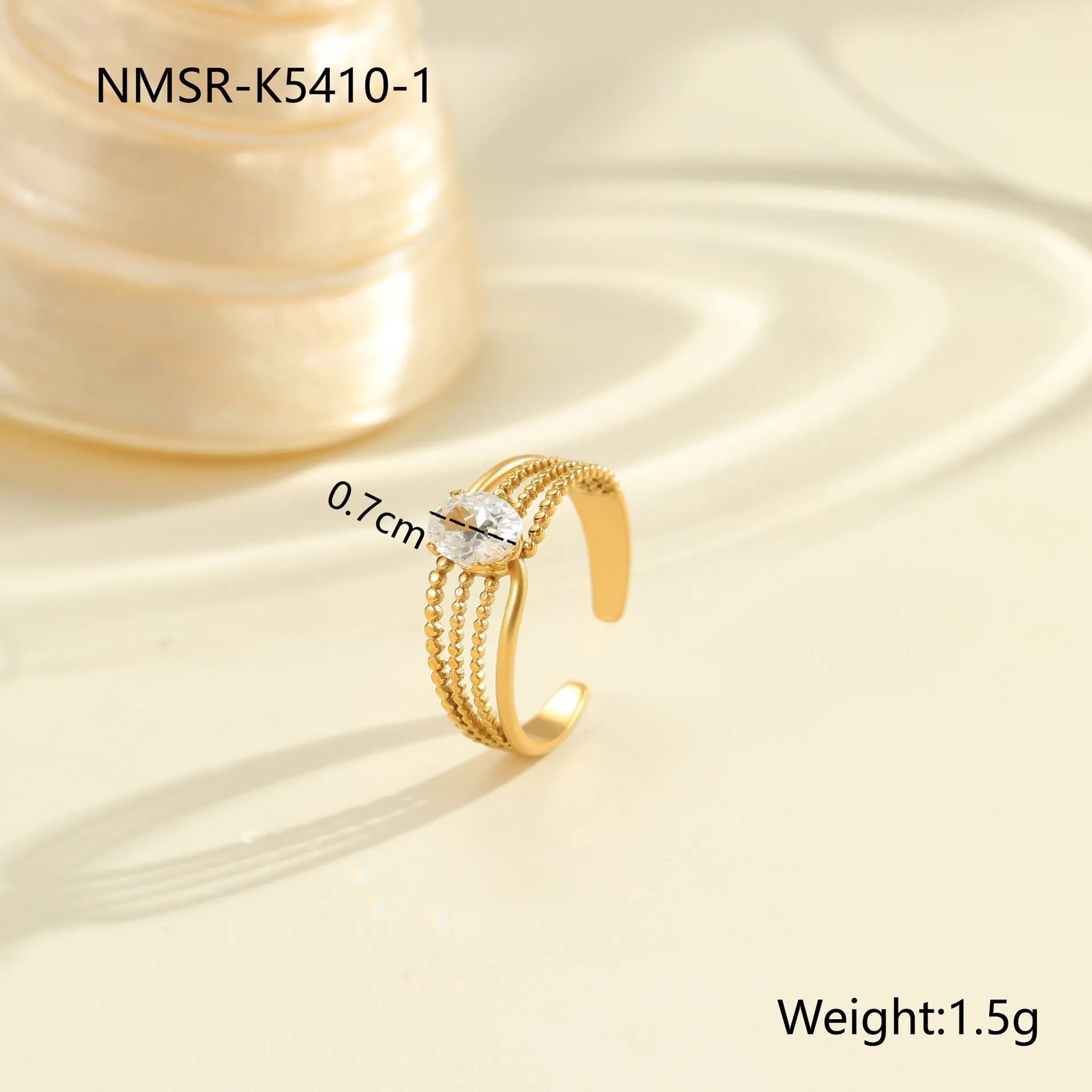 Gold electroplated adjustable ring with geometric zircon design on a stainless steel band.