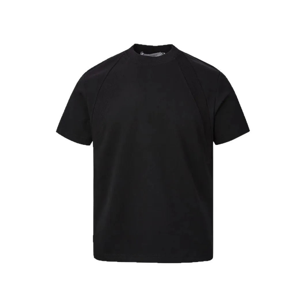 Men's loose fit short sleeve top in black with air layer stitching detail on a grey background.
